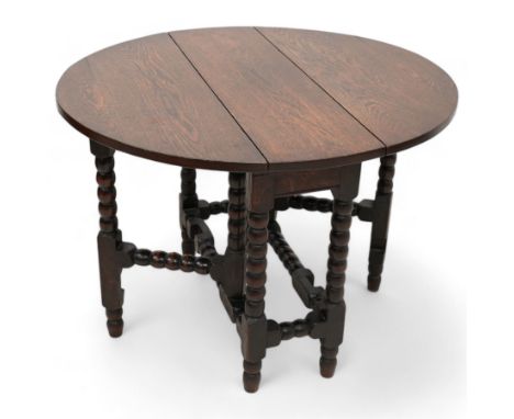 Small 17th century design oak drop-leaf, table oval top over bobbin-turned gate-leg supports, united by stretchersDimensions: