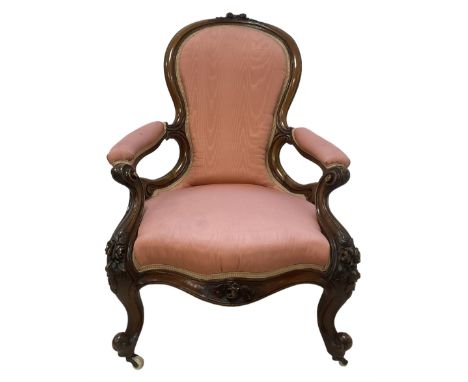 Victorian mahogany framed open armchair, spoon-back and sprung seat upholstered in pink fabric, scrolled arm terminals over s