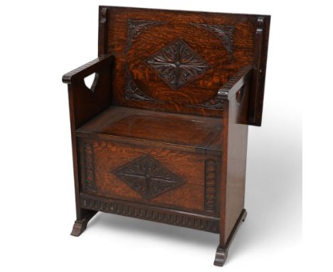 Early-to-mid-20th century carved oak monk's bench, metamorphic top with foliate lozenge carvings, over box seat with hinged l
