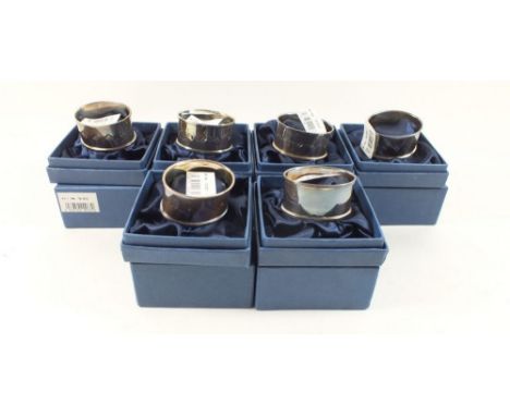 A set of six silver napkin rings, boxed 