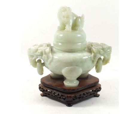 A carved green 'jade' pot and cover  with dog of fo finial and shoulders, 18cm tall with stand 
