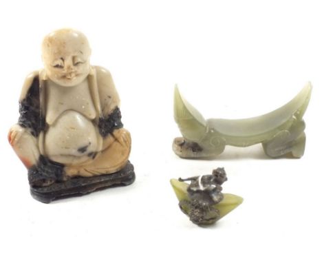 A Chinese jade carved arm rest, a jade and white metal lion miniature and a soapstone buddha 