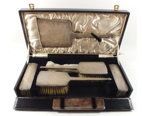 A silver five piece Art Deco brush set