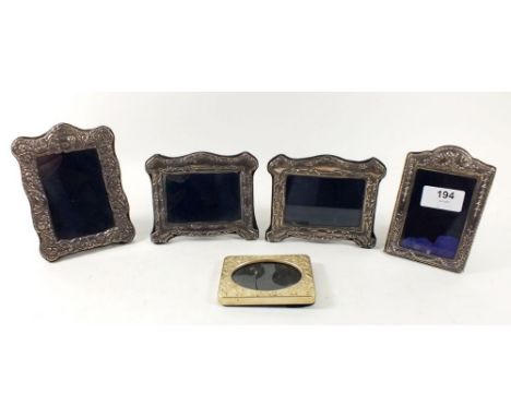 Four miniature silver photograph frames with embossed decoration, Sheffield various date marks, largest 13.5cm high together 