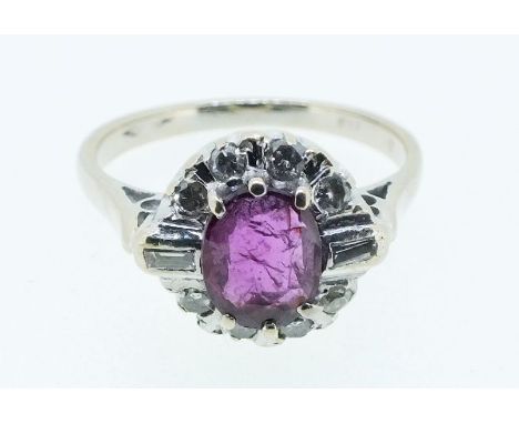 An 18 carat white gold ruby and diamond cluster ring with baguette and brilliant cut stones, size J 