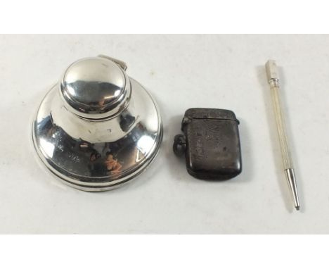 A small captstan silver inkwell, Chester 1920, a silver vesta Birmingham 1912 and a silver extending pencil 