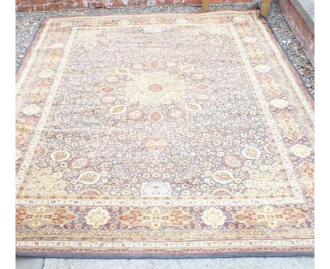 A large Persian style carpet in yellow and brown 