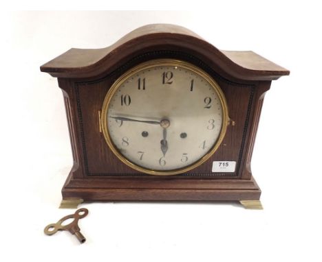 An oak arch mantel clock 