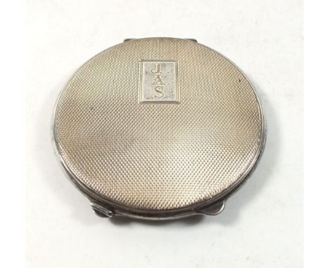 A silver compact with engine turned decoration, monogrammed JAS, Birmingham 1951