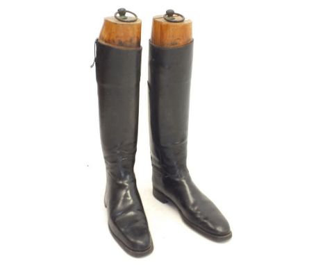 A pair of old leather hunting boots with wooden trees
