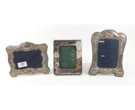 Two silver photograph frames with ornate decoration, Sheffield 1991 and 1992, 20 x 14cm and 14 x 17cm together with another h