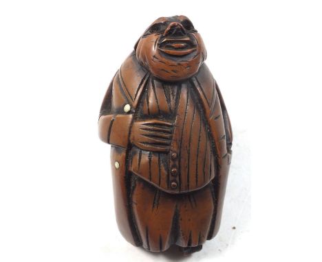 A Victorian snuff box in the form of an old man, his tail coat forming the hinged lid 