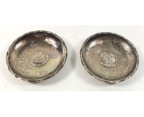 A pair of sterling silver Chinese pin dishes decorated with dragons and inset Chinese coins Kwang Ting province, 7.5cm diamet