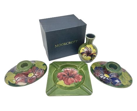 Pair of Moorcroft candlestick holders in Clematis pattern, together with Moorcroft ashtray and vase of squat baluster form, b