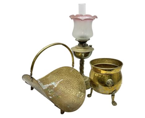 Brass log basket, with swing handle, upon four cast foliate feet, together with a brass planter, of circular bellied form, wi