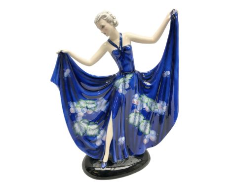 20th century American Goldscheider Art Deco figure, female in blue dress decorated with vines and grapes, holding up her skir