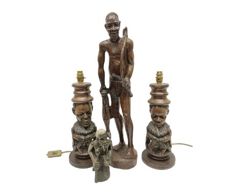 Pair of 20th century carved wood table lamp with African busts and figures, together with a carved wooden figure and soapston