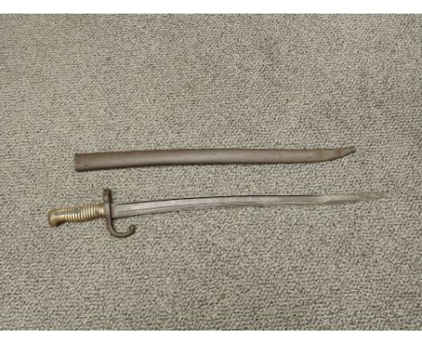 A French Sword Bayonet for the Chassepot Rifle 1866, blade edge etched 1873, brass grip, metal scabbard, blade length 57cm, o