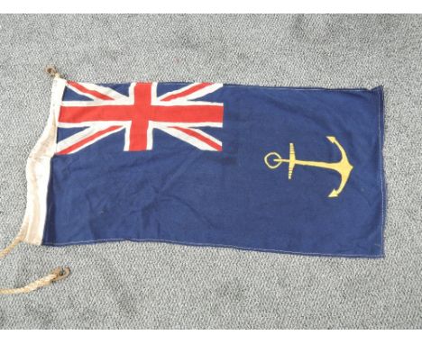 A Royal Navy Flag, blue withy union jack and anchor, Government Service Ensign,  most commonly seen flown by warships undergo