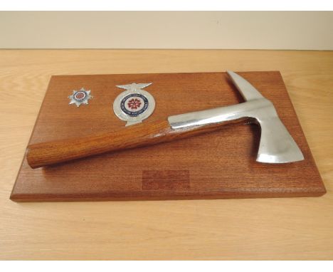 A Lancashire Fire and Rescue Service presentation Axe and Badge mounted on wooden plinth along with a Lancashire County Counc