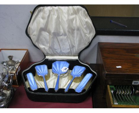 A Hallmarked Silver and Blue Enamel Dressing Table Set, comprising hand mirror, two pairs of brushes and a comb (teeth damage