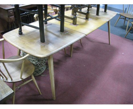 An Ercol Light Ash Extending Dining Table, on splayed legs, (top stained).