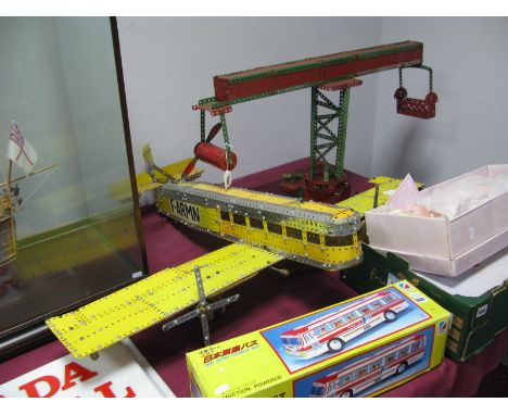 An Early XIX Century Model of a Circular Fairground Ride, made up in red and green Meccano parts; together with a large model