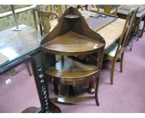 A XIX Century Mahogany Corner Washstand, with a shaped back with upper shelf, single drawer, two dummy drawers, on swept legs
