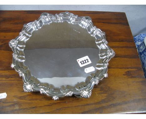 A Hallmarked Silver Salver, MT, Sheffield 1973, of shaped circular design, raised on three shell feet, 27cm diameter. 