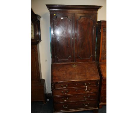 A LATE GEORGIAN MAHOGANY BUREAU BOOKCASE, PANELED TWIN DOOR UPPER SECTION. THE LOWER SECTION WITH FITTED INTERIOR, FOUR DRAWE