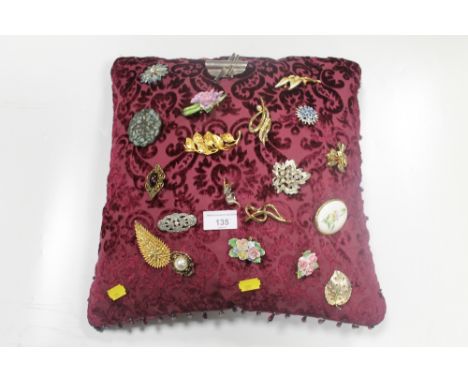 A CUSHION OF BROOCHES 