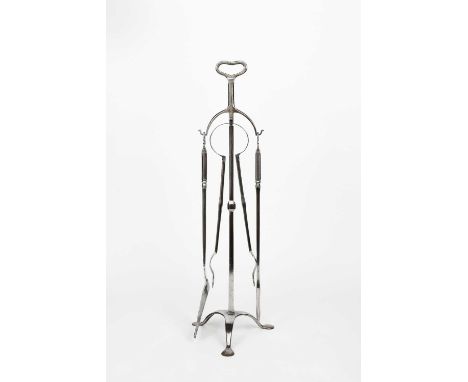 A set of polished wrought iron fire tools on a stand designed by Ernest Gimson, possibly made by Alfred Bucknell comprising f