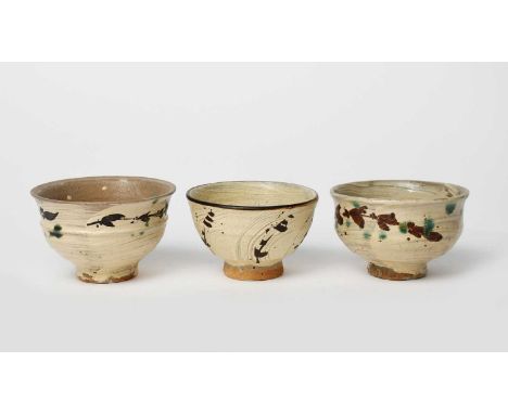 Jim Malone (born 1946)Footed bowlthree stoneware footed bowls, each covered in a brushed glaze, painted with simple grass mot