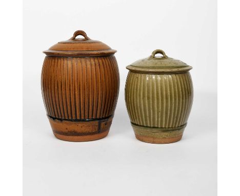 Φ Phil Rogers (1951-2020)Storage jar and coverstoneware, fluted swollen body, glazed to the foot in a dark tan glaze, and ano