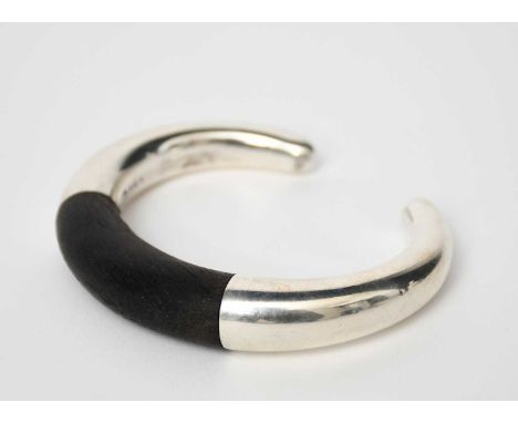 A Georg Jensen Aura silver and ebony bangle designed by Anna Ammitzbøll, model no.A33B, stamped marks, 7.5cm. wide   Georg Je