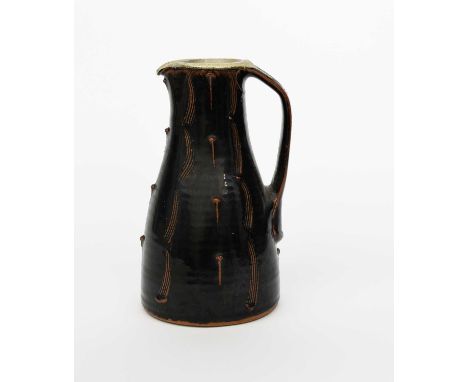 Φ Phil Rogers (1951-2020)Stoneware juga tall stoneware jug, incised, combed and slip decoration under a tenmoku glaze, the in
