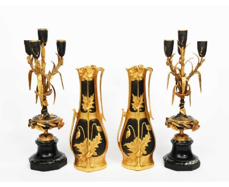 LesueusA pair of Art Nouveau gilt patinated bronze vases, slender bottle form, cast in low relief with panels of flower and f