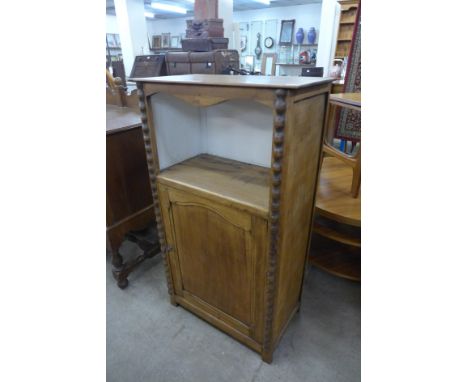 A 19th century French fruitwood bobbin single door cupboard 