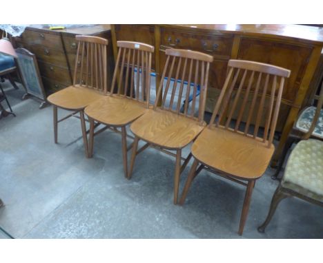 A set of four beech stick back kitchen chairs 