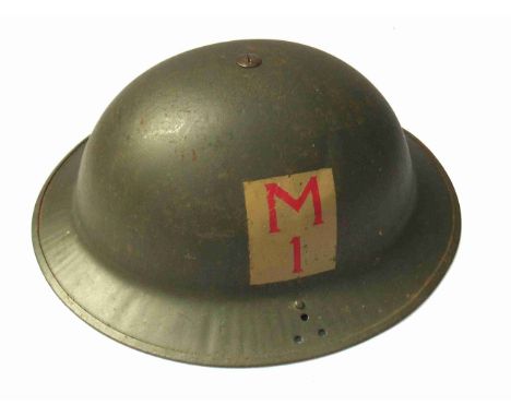A WWII Home Guard helmet with Division patch, stamped JSS 1940 to rim