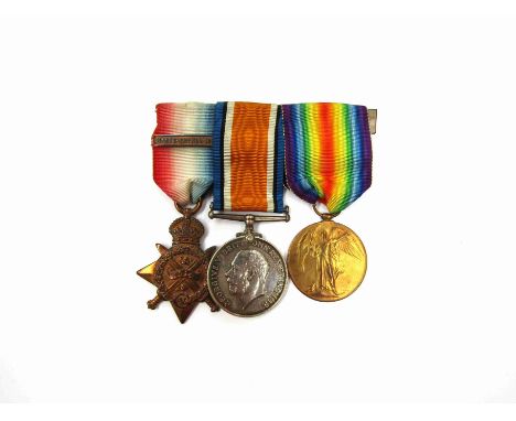  A World War I Mons Star 1914 medal trio with clasp, named to 63733 GNR G.E. Glover RFA / RA with comrades dinner ticket 
