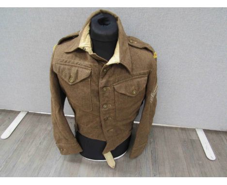 A 1940 pattern battledress blouse with RAC titles, dive patches, Corporal stripes etc