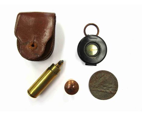 An early 20th Century military compass "The Magnapole", cased, together with Lusitania medal and trench art cylindrical light
