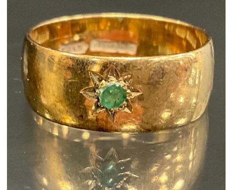 A 9ct gold emerald accented wedding band, size R/S, 5.3g gross