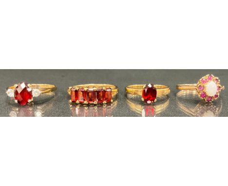 A opal and ruby cluster ring, 9ct gold shank, Birmingham 1954, size N;  Cz and red garnet dress ring, 9ct gold shank, others 