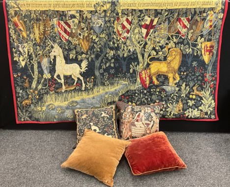 A 20th century tapestry, decorated with a Medieval style woodland scene, with lion and unicorn, 126cm x 195cm; six cushions, 