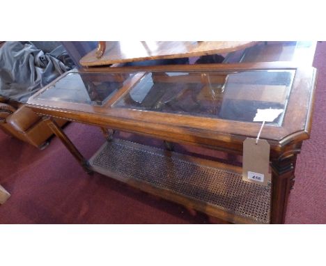 A 20th century mahogany console table, with glass top, cane lower tier, H.69 W.134 D.40cm 