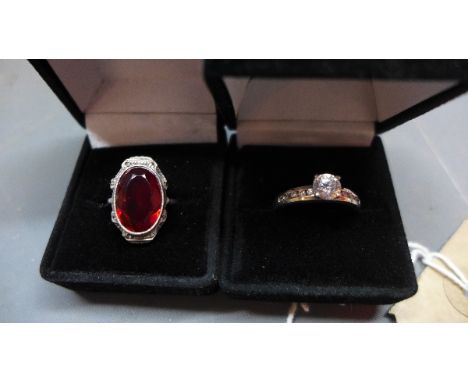 A silver and red semi precious stone inset dress ring, together with a white metal and cubic zirconia ring, (2) 