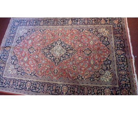 An extremely fine Central Persian Kurk Kashan rug, the central medallion on a light red field with repeating spandrels within