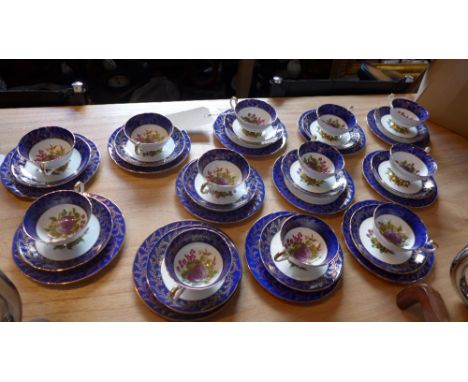 An Imperial porcelain tea set for twelve, comprising of cups, saucer and plates, decorated with grapes,plums and berries 